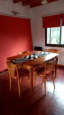 a dining room table and two chairs with a table and a window at Casa Magnolia in Merlo
