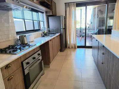 a kitchen with a stove top oven next to a window at Casa a 5 minutos de Villa Carlos Paz in Villa San Nicolás