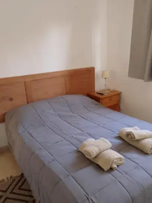 a bedroom with a bed with two towels on it at Departamento del golf in Alta Gracia