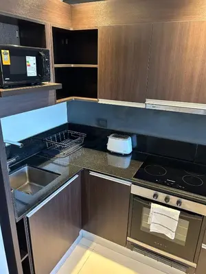 a kitchen with a sink and a stove top oven at France Golf Apart - Flat Deluxe con estacionamiento privado, pileta y gimnasio in Río Cuarto