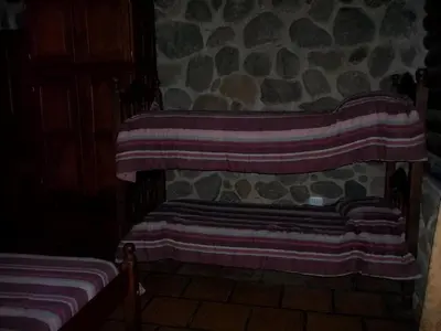 a room with two beds with striped blankets at Cabañas Mc Charlie in Santa Rosa de Calamuchita