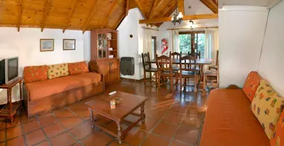 a living room with a couch and a table at Graz Hauser Cabañas in Villa General Belgrano