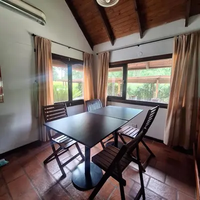 a dining room with a black table and chairs at Aparts Duendes del Arroyo in Villa General Belgrano
