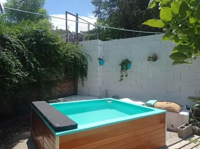a small swimming pool in a backyard at Casita Meraki para 2 personas in Villa Carlos Paz