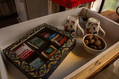 a box of chocolate and a bowl of peanuts on a counter at Casita Meraki para 2 personas in Villa Carlos Paz