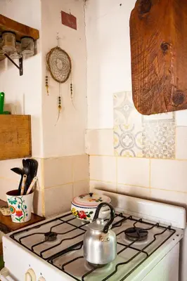 a tea kettle sitting on top of a stove in a kitchen at Casita Meraki para 2 personas in Villa Carlos Paz