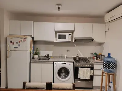 a kitchen with a washing machine and a refrigerator at Luminous department for 2 Ubicado a 10 cuadras de Shopping Nuevocentro in Cordoba