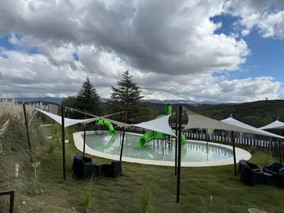 a swimming pool with umbrellas and chairs around it at Graciana Residence H 11 JUNIO reserva mínima 3 noches in Trapiche