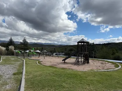 a playground with a slide in a park at Graciana Residence H 11 JUNIO reserva mínima 3 noches in Trapiche