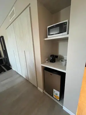 a room with a kitchen with a microwave and a door at Graciana Residence H 11 JUNIO reserva mínima 3 noches in Trapiche
