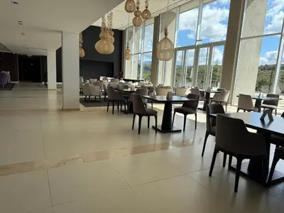 a dining room with tables and chairs and windows at Graciana Residence H 11 JUNIO reserva mínima 3 noches in Trapiche