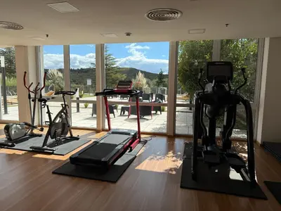 a gym with treadmills and exercise bikes in a room at Graciana Residence H 11 JUNIO reserva mínima 3 noches in Trapiche