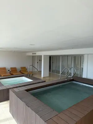 a large swimming pool in a building with chairs at Graciana Residence H 11 JUNIO reserva mínima 3 noches in Trapiche