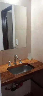 a bathroom sink with a mirror on a wooden counter at Cabaña cp in Villa General Belgrano