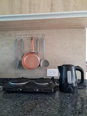 a kitchen counter with a tea pot and utensils at Terrazas al Golf in Alta Gracia