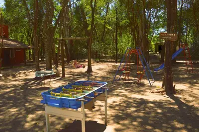 a park with a playground and a swing set at Cabañas Altos Del Parque in Villa Ciudad Parque
