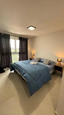a large blue bed in a room with a window at Guesthouse Luxury in Cordoba