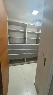 a closet with white shelves in a room at Guesthouse Luxury in Cordoba