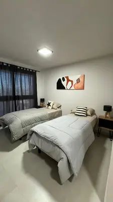 a bedroom with two beds and a painting on the wall at Guesthouse Luxury in Cordoba