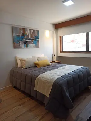 a bedroom with a large bed in a room at Moderno y cómodo monoambiente céntrico con amenities y SEGURIDAD 24hs in Cordoba