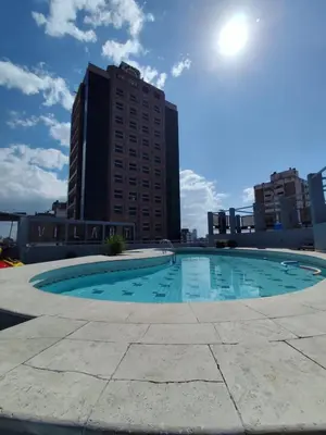 a large swimming pool in the middle of a city at Moderno y cómodo monoambiente céntrico con amenities y SEGURIDAD 24hs in Cordoba