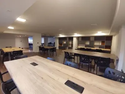 a large room with tables and chairs in a building at Moderno y cómodo monoambiente céntrico con amenities y SEGURIDAD 24hs in Cordoba