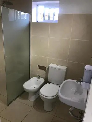 a bathroom with a toilet and a sink at Cabañas Al atardecer in Mina Clavero