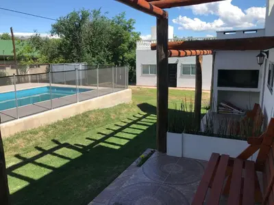 a backyard with a swimming pool and a fence at Cabañas Al atardecer in Mina Clavero