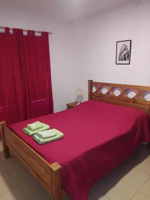 a bedroom with a bed with two towels on it at Luma Departamento, con Pileta in Villa Dolores