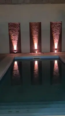 a swimming pool with three lights on top of it at Luma Departamento, con Pileta in Villa Dolores