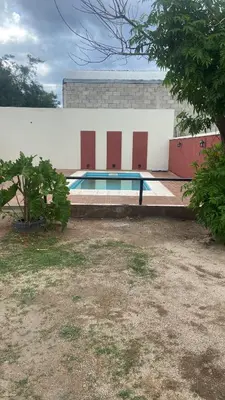 a swimming pool in front of a building at Luma Departamento, con Pileta in Villa Dolores