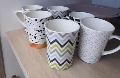 a group of coffee mugs sitting on a shelf at Cabañas Tinkuy II in Cortaderas