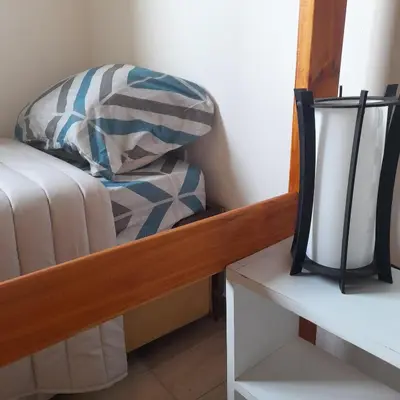 a bedroom with a bed and a mirror at Cabañas Tinkuy II in Cortaderas