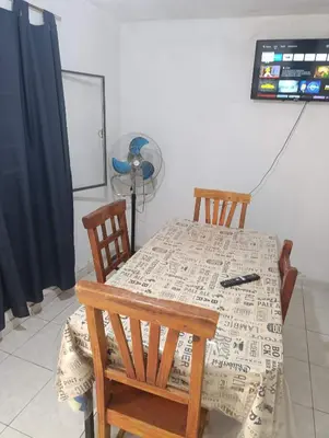 a dining room table with two chairs and a fan at El ROBLE 2 in Cordoba