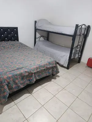 a bedroom with two bunk beds and a tiled floor at El ROBLE 2 in Cordoba