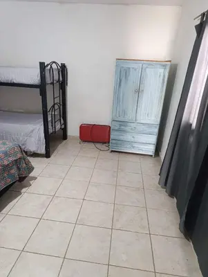 a room with a bed and a dresser and a tiled floor at El ROBLE 2 in Cordoba