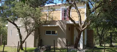 a house with trees in front of it at Suspiro de Montaña in La Rancherita