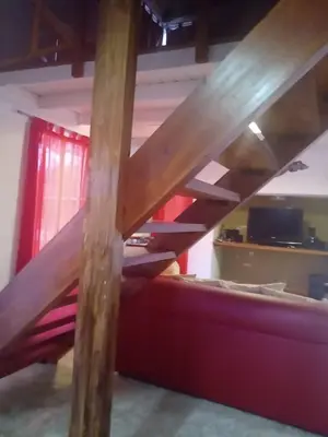 a loft bed in a room with a couch at Suspiro de Montaña in La Rancherita