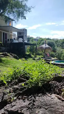 a yard with a umbrella and a house at Suspiro de Montaña in La Rancherita