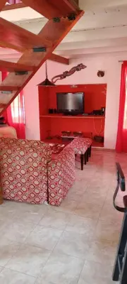 a living room with a couch and a flat screen tv at Suspiro de Montaña in La Rancherita