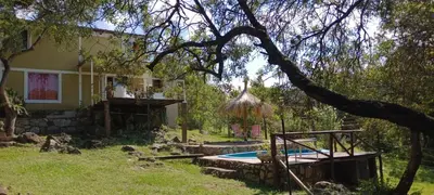 a house with a swimming pool in the yard at Suspiro de Montaña in La Rancherita