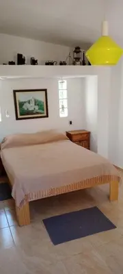 a bedroom with a large bed with a yellow ceiling at Suspiro de Montaña in La Rancherita