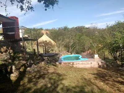 a swimming pool in the yard of a house at Suspiro de Montaña in La Rancherita
