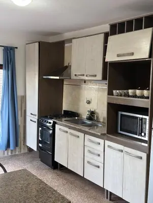 a kitchen with a stove and a sink at Playas Doradas in Villa Anizacate