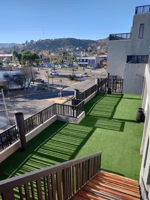 a balcony with green grass on a building at Village Tower III sobre Av San Martín, Cochera in Villa Carlos Paz