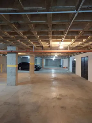 an empty parking garage with a car parked in it at Village Tower III sobre Av San Martín, Cochera in Villa Carlos Paz