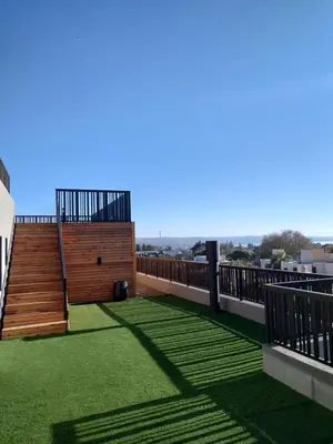a balcony with green grass and stairs on a building at Village Tower III sobre Av San Martín, Cochera in Villa Carlos Paz