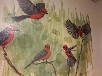 a painting of birds and butterflies on a wall at Pousada elisa in Cordoba