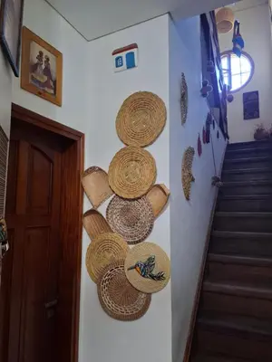 a hallway with straw hats on a wall at Pousada elisa in Cordoba
