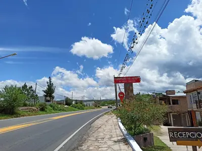 a street with a sign on the side of a road at Complejo EL ALTO in Tanti